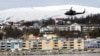 A helicopter patrols off Tromsoe, Norway, June 2, 2012. REUTERS/Saul Loeb/Pool/File Photo