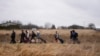 People walk with their belongings, as they flee Ukraine, at the border crossing in Medyka, Poland, March 5, 2022. 