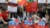 FILE - Filipino student activists set fire mock Chinese ships to protest recent island-building and alleged militarization by China off the disputed Spratlys group of islands in the South China Sea, in Manila, March 3, 2016. 