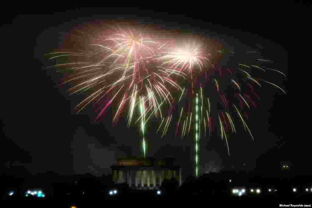 The Independence Day fireworks are set off above the Washington, D.C., skyline over the Lincoln Memorial; as seen from Arlington, Virginia, July 4, 2016.