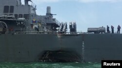 FILE - The U.S. Navy guided-missile destroyer USS John S. McCain is seen after a collision, in Singapore waters Aug. 21, 2017. 