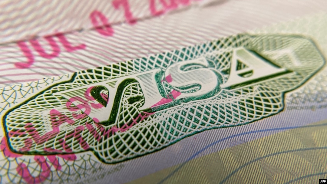 FILE - A photo illustration shows a U.S. visa stamp on a foreign passport in Los Angeles, California, June 6, 2020.