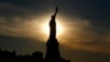 The sun rises behind the Statue of Liberty a day before the United States celebrates its independence, July 3, 2016, in Jersey City, N.J. 