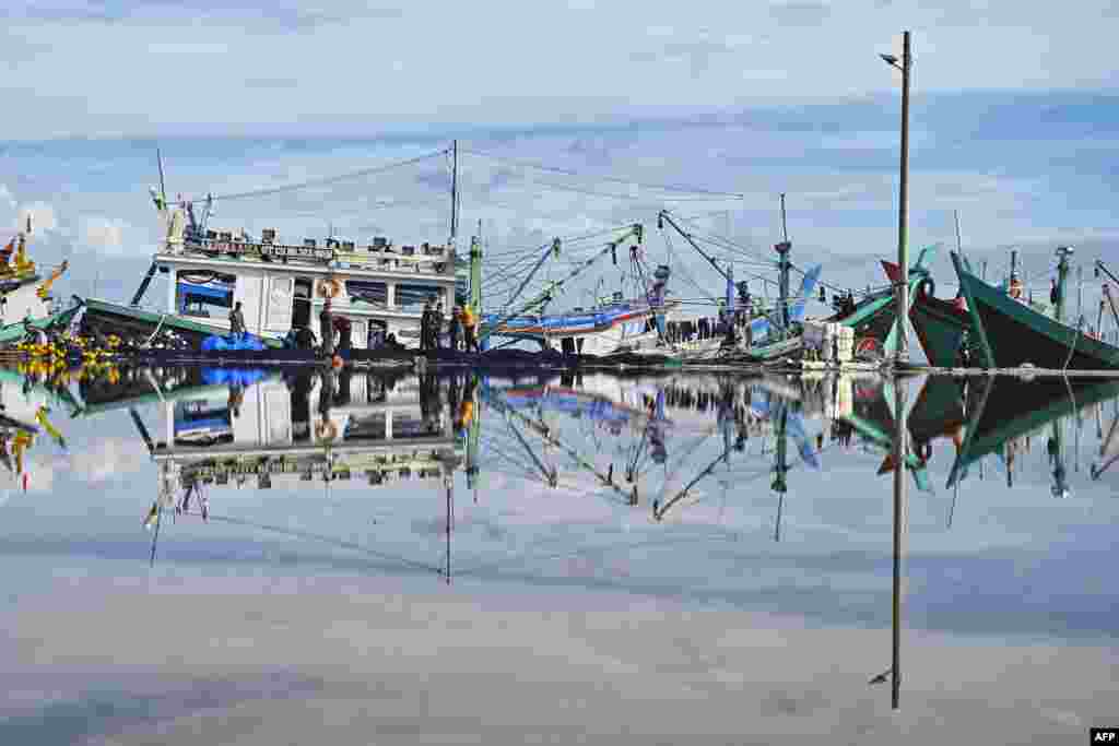 Fishermen check their nets during "no fishing Friday" at a port in Banda Aceh, Indonesia.