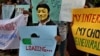FILE - An activist wears a mask as he holds a placard during a demonstration supporting net neutrality, in Bangalore, India, .