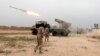 FILE - Iraqi soldiers fire a rocket toward Islamic State militants on the outskirt of the Makhmour south of Mosul, Iraq, March 25, 2016. 