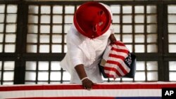 A mourner pauses by the casket of Rep. John Lewis lying in repose at the Georgia State Capitol, July 29, 2020, in Atlanta.
