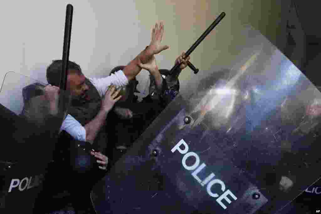 Anti-government protesters scuffle with riot police outside the ministry of Justice, in Beirut, Lebanon.&nbsp;Scores of protesters scuffled with riot police as they tried to break into the Beirut Justice Palace, rejecting an order from Lebanon&#39;s judiciary that further crippled the probe into a massive port explosion over two years ago.