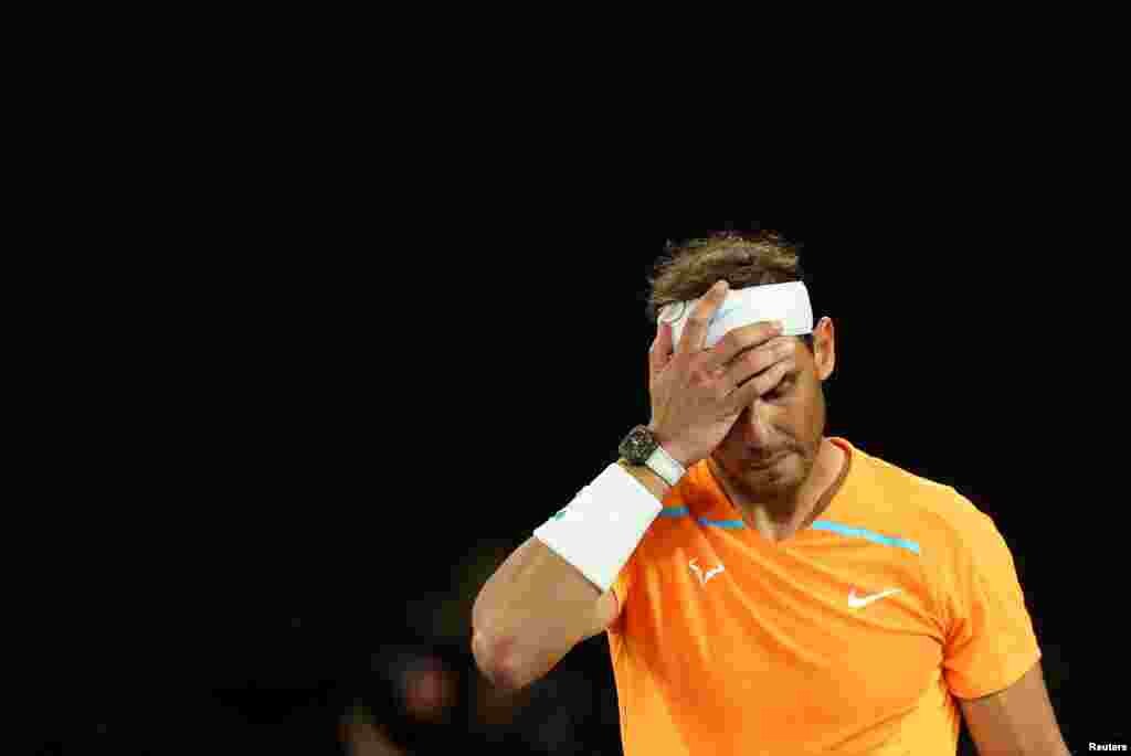 Spain&#39;s Rafael Nadal looks dejected after losing his second round match against Mackenzie Mcdonald of the U.S. during the Australia Open tennis championship in Melbourne Park, Melbourne.