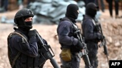 FILE - Georgian special police patrol the Georgian-South Ossetian border at a check point in the Kvemo Kartli region some 120 km outside Tbilisi on Aug. 30, 2019.