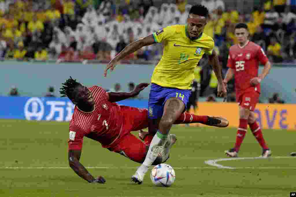 Switzerland&#39;s Breel Embolo, left, and Brazil&#39;s Eder Militao vie for the ball during the World Cup group G soccer match between Brazil and Switzerland, at the Stadium 974 in Doha, Qatar.