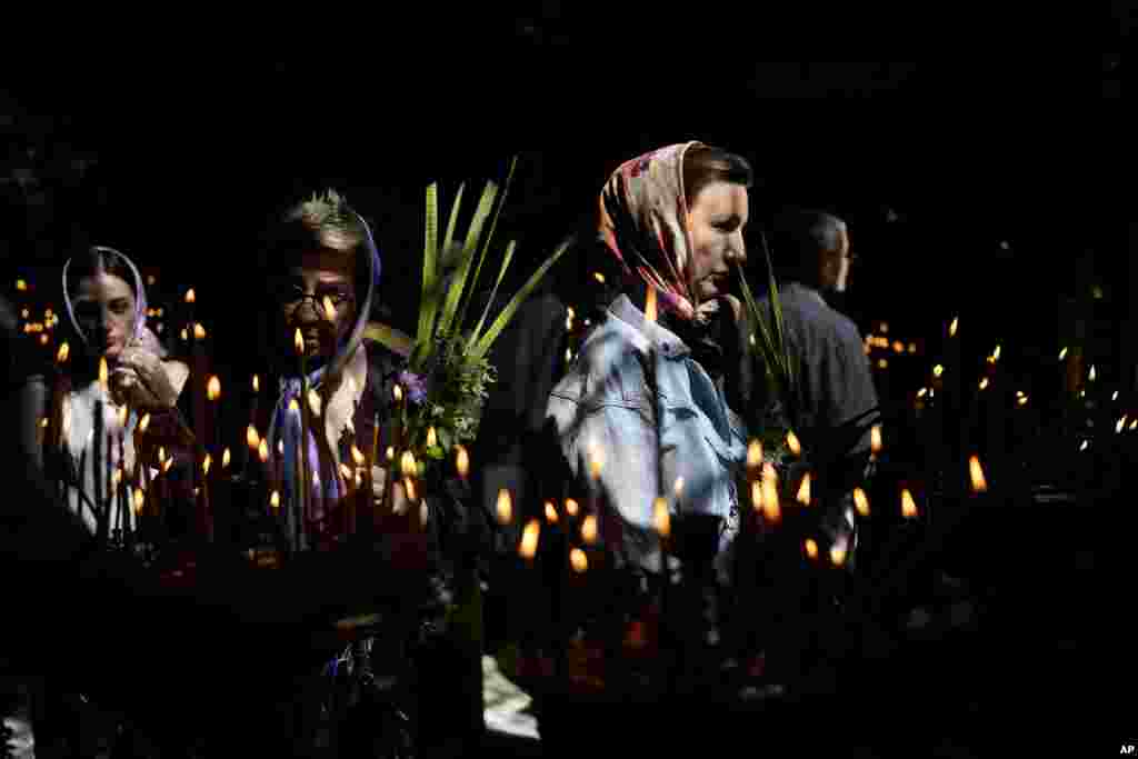 Women attend a Mass at St. Volodymyr&#39;s Cathedral during Orthodox Pentecost in Kyiv, Ukraine.