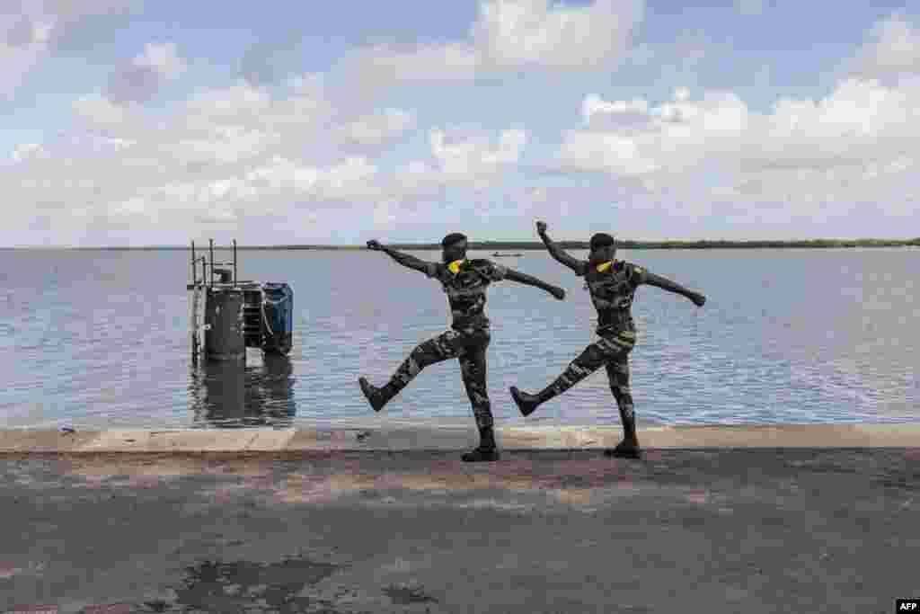 Two members of the Senegalese Armed Forces march during a ceremony for the 20th anniversary of the capsizing of "Le Joola" in Ziguinchor. The ferry, which sank between Dakar and Ziguinchor, left 1,863 dead, according to the official report.