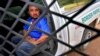 A 38-year-old man from Mexico City sits in a U.S. Border Patrol vehicle, Sept. 8, 2022, near Sasabe, Arizona.