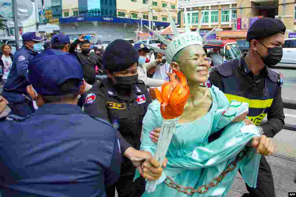Cambodian-U.S. human rights advocate Theary Seng, dressed as Lady Liberty, is arrested by police in front of the Phnom Penh municipal court.&nbsp;A Cambodian court handed down jail sentences to about 60 opposition figures including Theary Seng for conspiring to commit treason, in a mass trial condemned by the United States and rights groups as politically motivated.
