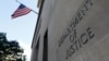 FILE - Signage is seen at the United States Department of Justice headquarters in Washington, Aug. 29, 2020. 