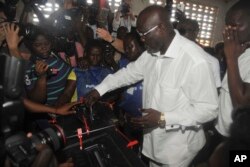 FILE - Former soccer star George Weah, presidential candidate for the Coalition for Democratic Change casts his vote during a presidential election in Monrovia, Liberia, Oct. 10, 2017.
