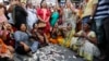 Supporters of India's main opposition Congress party tear toy currency notes and shout sloganS during a protest on the first anniversary of the Nov. 8 demonetization announcement, in Ahmadabad, India, Wednesday, Nov. 8, 2017. 