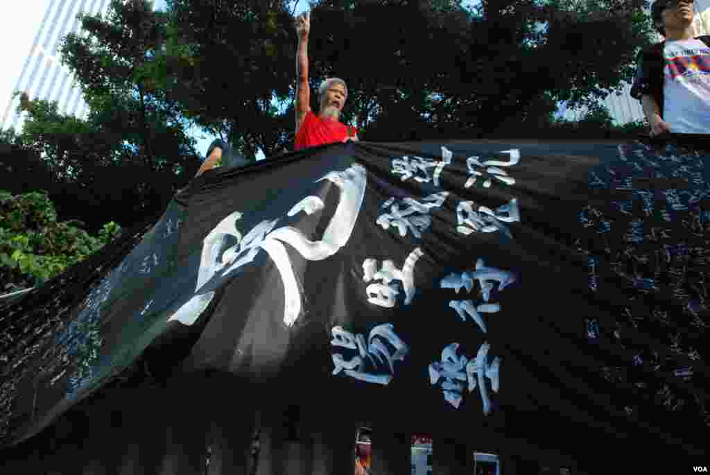 Some protesters climb up on large blocks.
