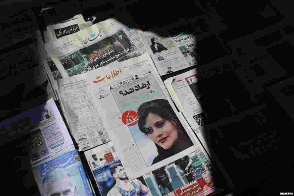 A newspaper with a cover picture of Mahsa Amini, a woman who died after being arrested by the Islamic republic&#39;s &quot;morality police&quot; is seen in Tehran, Iran, Sept. 18, 2022.