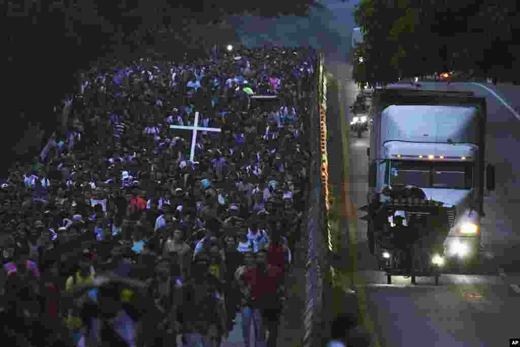 Migrants, many from Central American and Venezuela, walk along the Huehuetan highway in Chiapas state, Mexico.&nbsp;The group left Tapachula, tired of waiting to normalize their status in a region with little work and still far from their ultimate goal of reaching the United States.