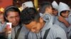 Cambodian trafficked fishermen return from Indonesia after being freed or escaping from slave-like conditions on Thai fishing vessels, talks to journalists at the Phnom Penh International airport on December 12, 2011. Thousands of men from Myanmar and Cam