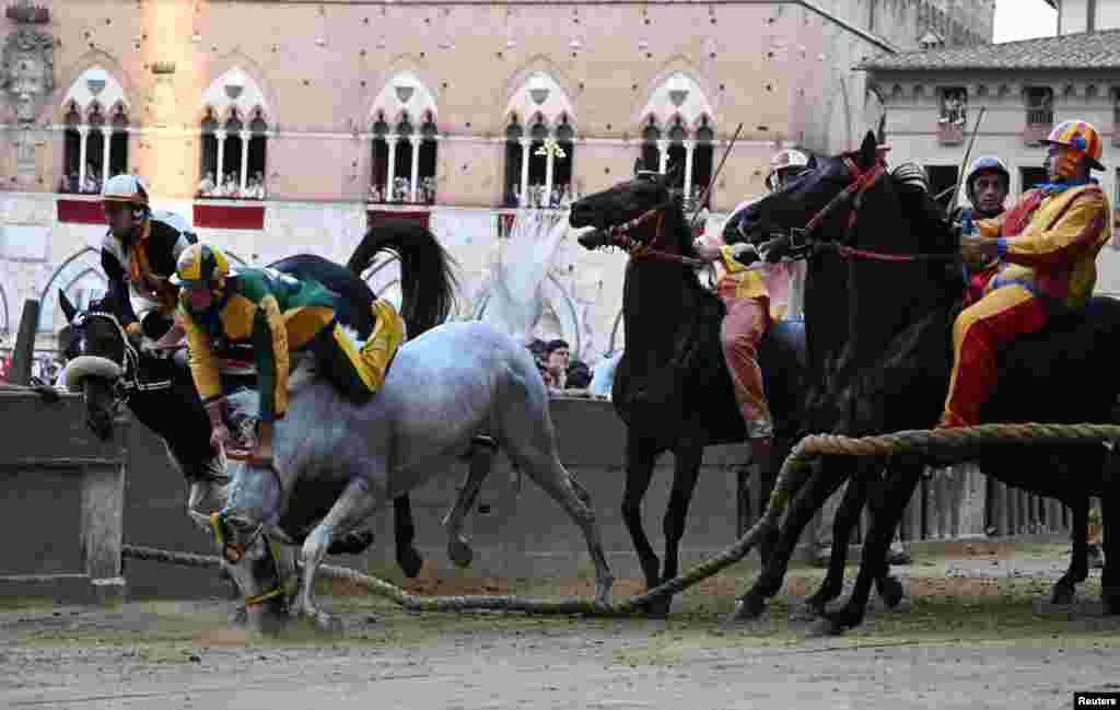 Bruco parish jockey Stefano Piras falls during a false start of his horse &#39;Uragano Rosso&#39; during the &quot;Palio di Provenzano&quot; horse race in Siena, Tuscany, Italy, July 2, 2022.