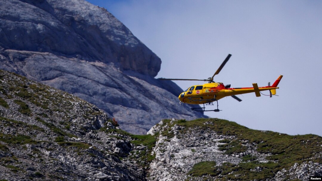 A helicopter participates in search and rescue operations at the site of a deadly collapse of parts of a mountain glacier in the Italian Alps, at the Dolomites' Marmolada ridge, Italy, July 5, 2022.