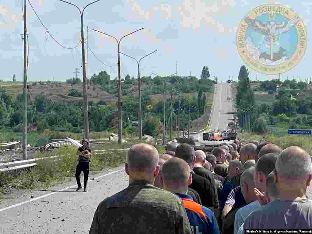 A man with a white flag walks along the road during an exchange of prisoners&nbsp;at a location given as Zaporizhzhia region, Ukraine as Russia&#39;s attack on Ukraine continues, June 29, 2022.
