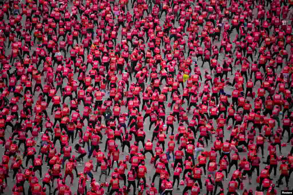 People attend a massive boxing class trying to set a new Guinness World Record for people taking a class at the same time for 30 minutes at the Zocalo square, in Mexico City, Mexico, June 18, 2022. 