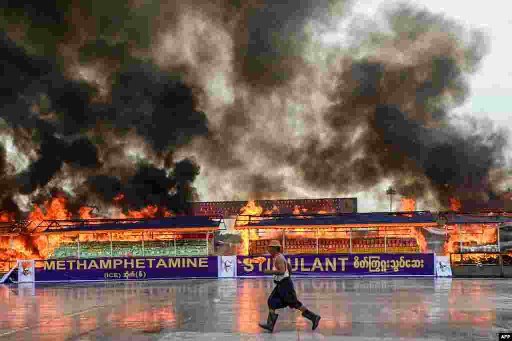 Smoke rises from a burning pile of seized illegal drugs during a destruction ceremony to mark the United Nations&#39; &quot;International Day against Drug Abuse and Illicit Trafficking&quot; in Yangon, Myanmar.