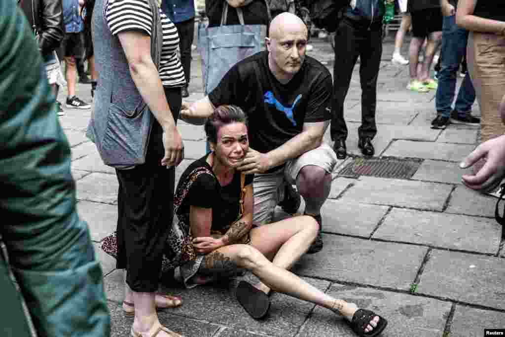 A woman reacts in front of the Field&#39;s shopping center, after Danish police said they received reports of a shooting at Field&#39;s shopping center, in Copenhagen, Denmark, July 3, 2022.