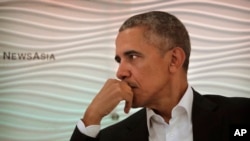 Former U.S. President Barack Obama listens to a question during a leadership summit in New Delhi, India, Dec. 1, 2017. 