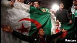 People celebrate on the streets after Algeria's President Abdelaziz Bouteflika has submitted his resignation, in Algiers, April 2, 2019. 