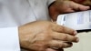 FILE - Human rights activist Ahmed Mansoor shows Associated Press journalists a screenshot of a spoof text message he received in Ajman, United Arab Emirates, Aug. 25, 2016. Mansoor was recently targeted by spyware that can hack into Apple's iPhone handset.