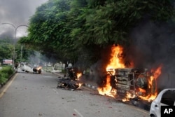 Vehicles set alight by Dera Sacha Sauda sect members burn in the streets of Panchkula, India, Aug. 25, 2017.