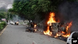 Vehicles set alight by Dera Sacha Sauda sect members burn in the streets of Panchkula, India, Aug. 25, 2017. 