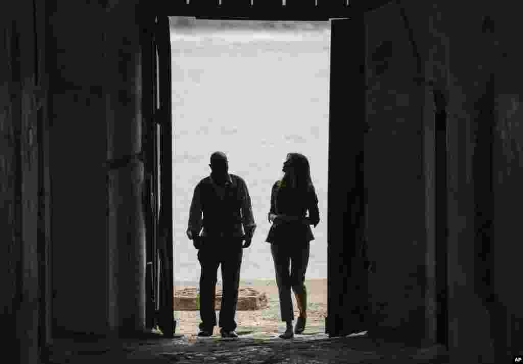 First lady Melania Trump looks up as she walks through the "Door Of No Return" with Cape Coast Castle museum educator Kwesi Essel-Blankson as she visits Cape Coast Castle in Cape Coast, Ghana, Oct. 3, 2018.