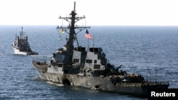 FILE - The U.S. Navy destroyer USS Cole is towed away from the port city of Aden, Yemen, into open sea, Oct. 29, 2000. 