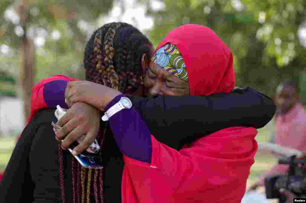 Members of the #BringBackOurGirls (#BBOG) campaign embrace each other in Abuja, Nigeria. A teenager kidnapped by Boko Haram more than two years ago has been rescued, the first of more than 200 girls seized in a raid on their school in Chibok town to return from captivity in the insurgents' forest lair, officials said.