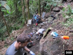 Members from Defense POW/MIA Accounting Agency (DPAA), remove soil from a test unit as part of a DPAA investigation mission near Bhismaknagar Village, Arunachal Pradesh, India, Dec. 01, 2016.