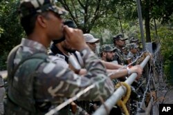 Indian paramilitary soldiers stand guard near an Indian court in Panchkula, India, Aug. 25, 2017.