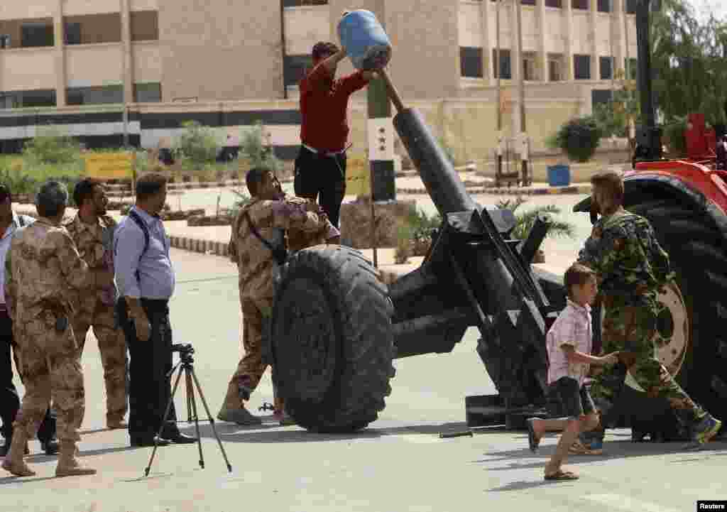 Free Syrian Army fighters prepare to fire a homemade rocket in Ashrafieh, Aleppo, Sept. 25, 2013.