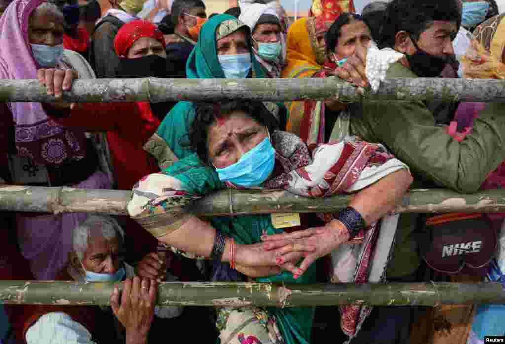 Hindu pilgrims arrive at the confluence of the river Ganges and the Bay of Bengal ahead of &quot;Makar Sankranti&quot; festival at Sagar Island, amidst the spread of the COVID-19 in the eastern state of West Bengal, India.