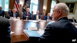 President Donald Trump, second from left, listens as Attorney General Jeff Sessions, right, speaks during a cabinet meeting in the Cabinet Room of the White House, Aug. 16, 2018, in Washington. 
