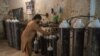 A worker fills oxygen tanks for use in hospitals in Peshawar, Pakistan, Dec. 7, 2020.