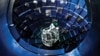 FILE - Technicians use a service system lift to access the target chamber interior for inspection and maintenance at the National Ignition Facility (NIF), at Lawrence Livermore National Laboratory federal research facility in Livermore, Calif., in 2008. 
