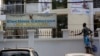 FILE - A man paints the fence of electoral commission ELECAM's offices in Yaounde, Cameroon, Oct. 10, 2018. 