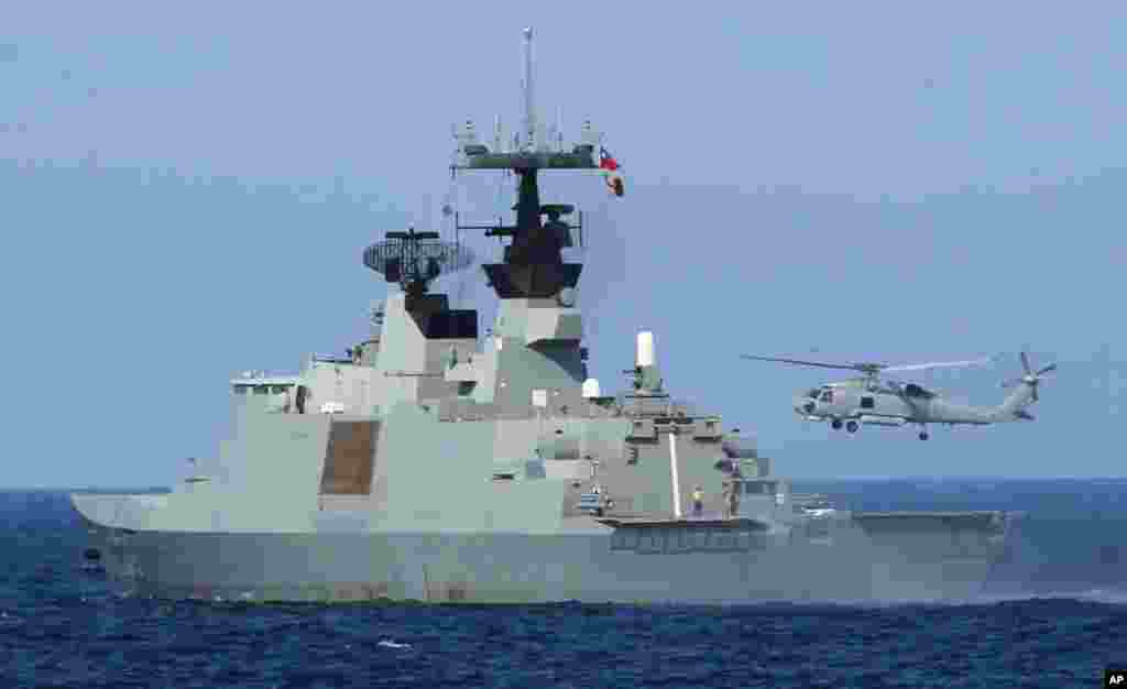 A helicopter takes off from the stern of a Taiwanese Lafayette frigate during exercises off the southern city of Kaohsiung,Taiwan, May 16, 2013.