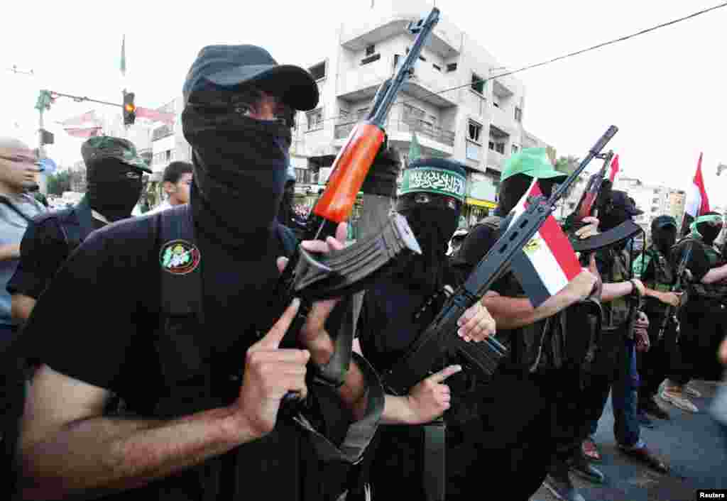 Hamas militants celebrate in the streets in Gaza City after Islamist Mohamed Morsi of the Muslim Brotherhood was declared Egypt's first democratic president, June 24, 2012. (Reuters)